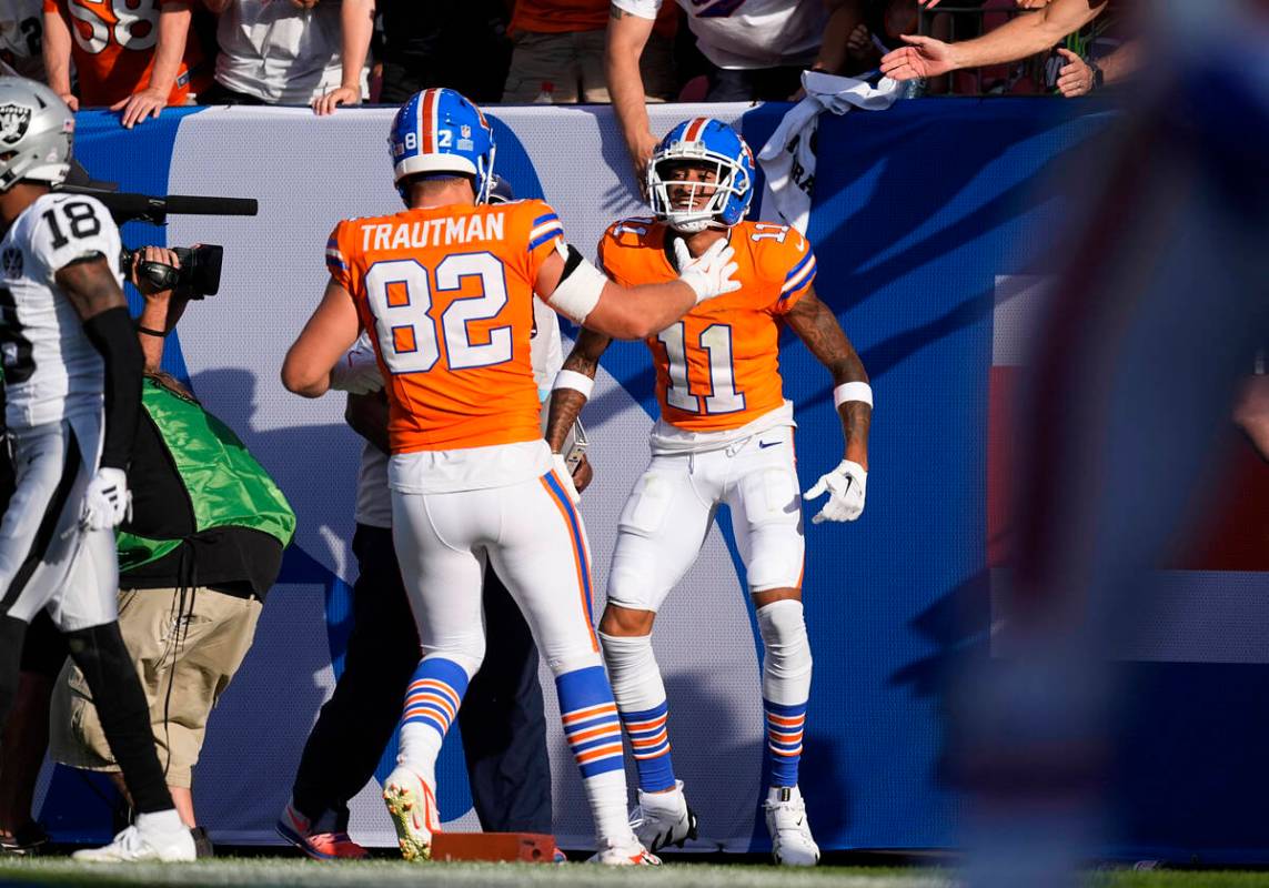 Denver Broncos tight end Adam Trautman, front, congratulates wide receiver Josh Reynolds after ...