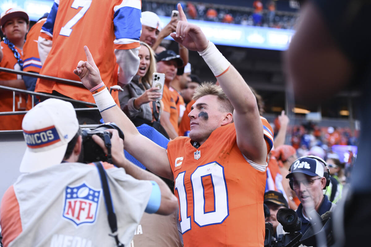 Denver Broncos quarterback Bo Nix gestures to fans as he heads off the field after an NFL footb ...