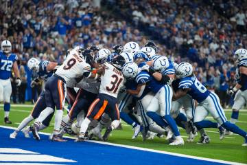 Indianapolis Colts running back Trey Sermon (27) is pushed across the goal line for a touchdown ...