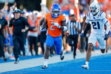 Boise State running back Ashton Jeanty (2) runs away from Utah State safety Malik McConico (21) ...