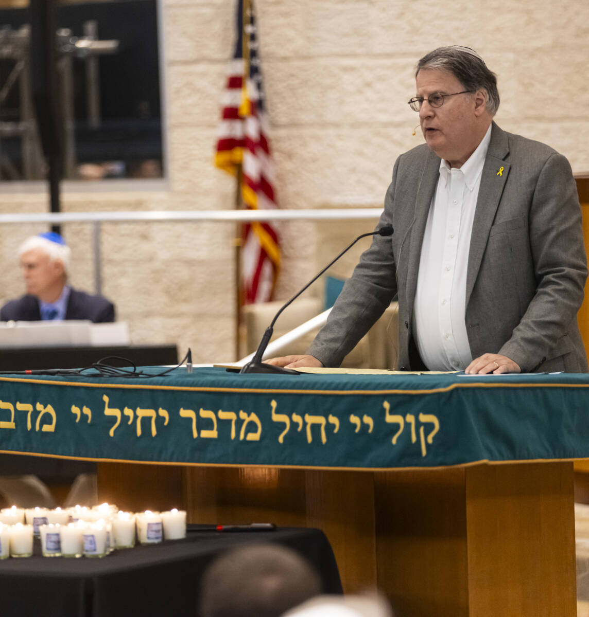 Dr. Elliott Malamute speaks during a ceremony at Midbar Kodesh Temple marking one year since th ...