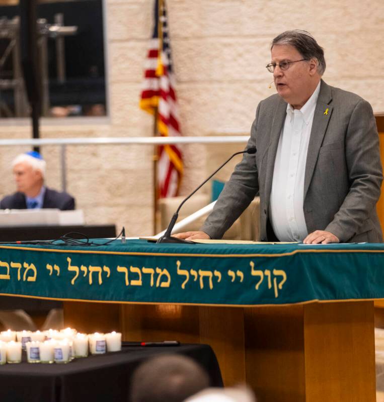 Dr. Elliott Malamute speaks during a ceremony at Midbar Kodesh Temple marking one year since th ...