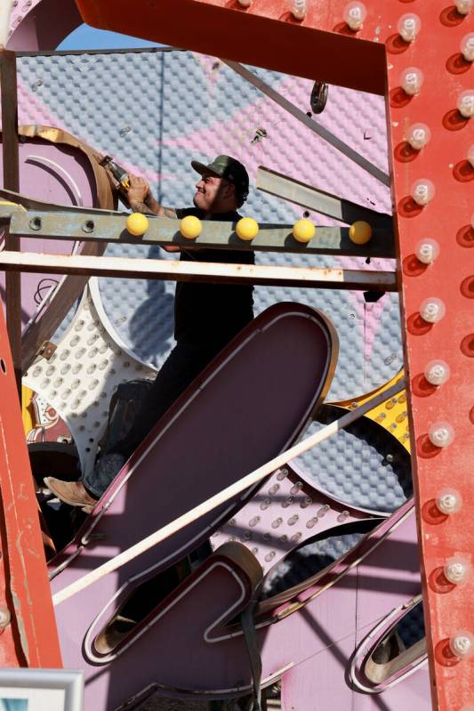 A YESCO sign company worker prepares to move the cursive sign from the Debbie Reynolds Hollywoo ...