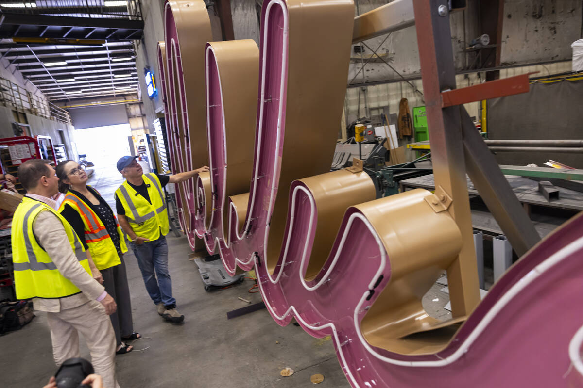 Todd Fisher, right, takes a look at the renovation progress with YESCO sign designer Lisa Adams ...