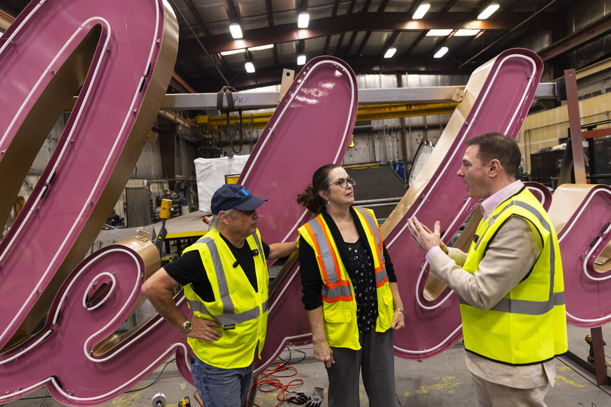 Todd Fisher, left, and YESCO sign designer Lisa Adams, an assistant original designer of the &# ...