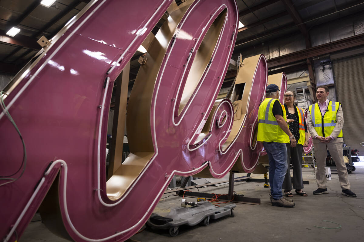 Todd Fisher, left, talks with YESCO sign designer Lisa Adams, an assistant original designer of ...