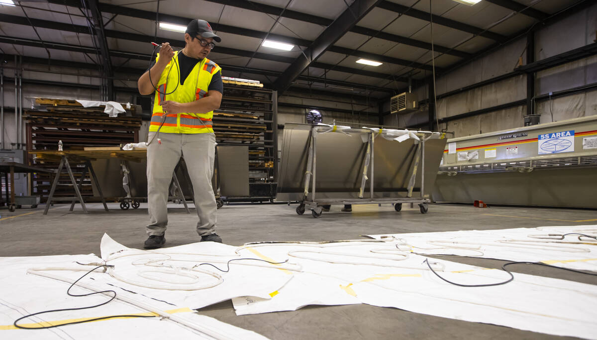 YESCO neon bender Oscar Gonzalez lines up new neon tubes for the renovation of the “Debbie” ...