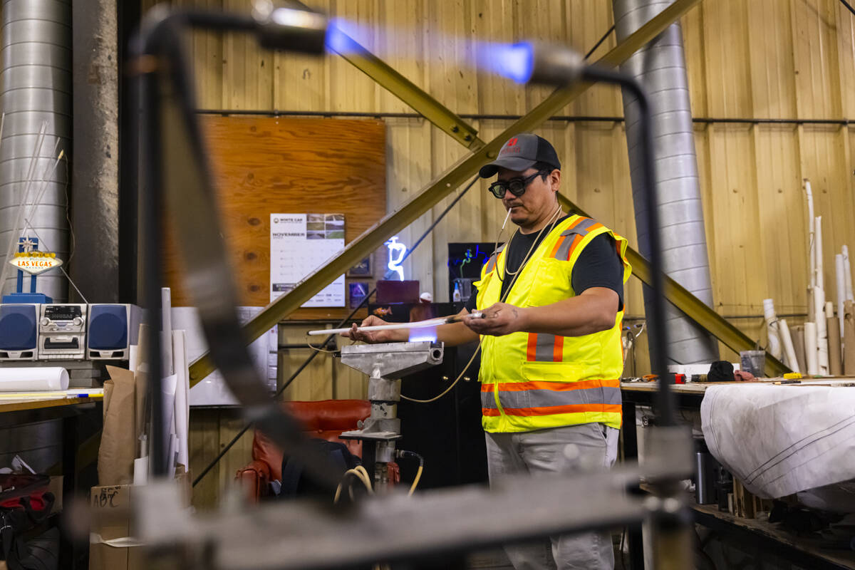 YESCO neon bender Oscar Gonzalez works on shaping a neon tube while working on the renovation o ...