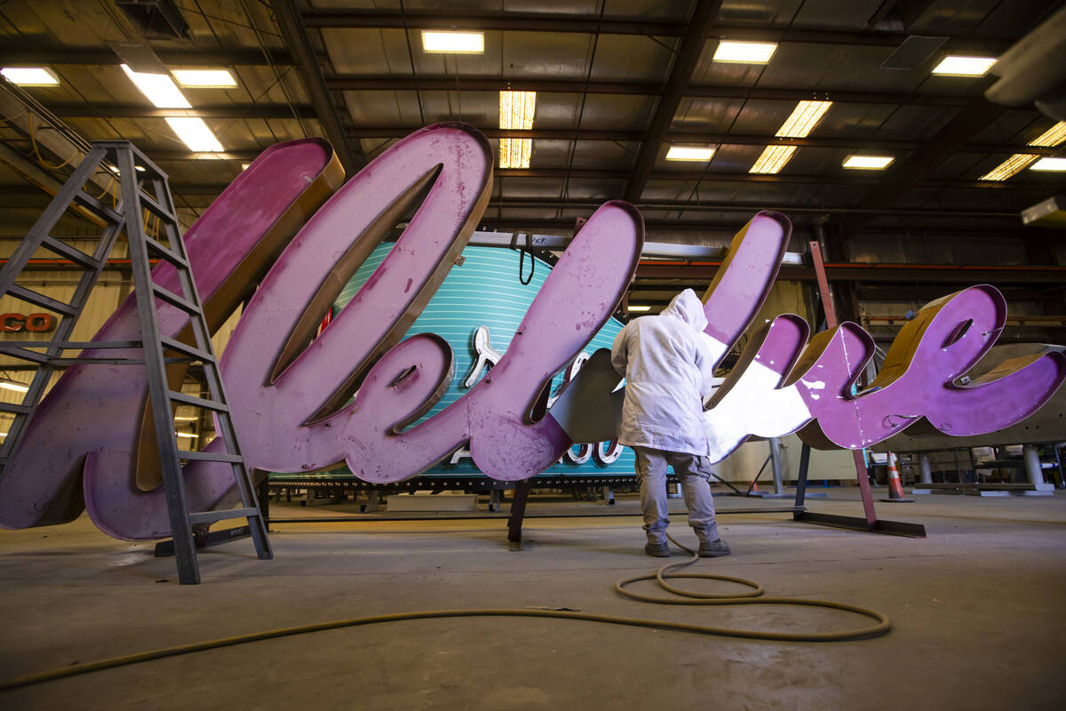 YESCO paint apprentice Cody Day sands down the “Debbie” sign from the former Debb ...