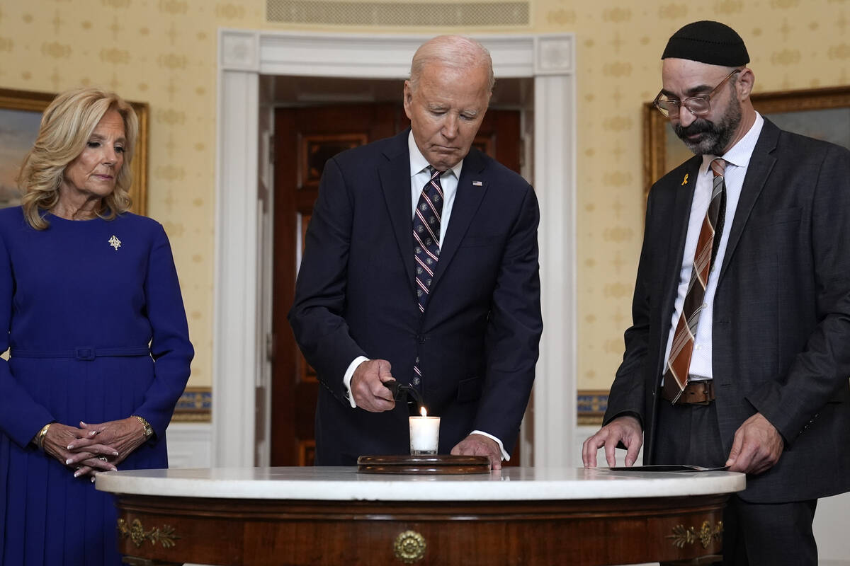 President Joe Biden, center, standing with first lady Jill Biden, left, and Rabbi Aaron Alexand ...