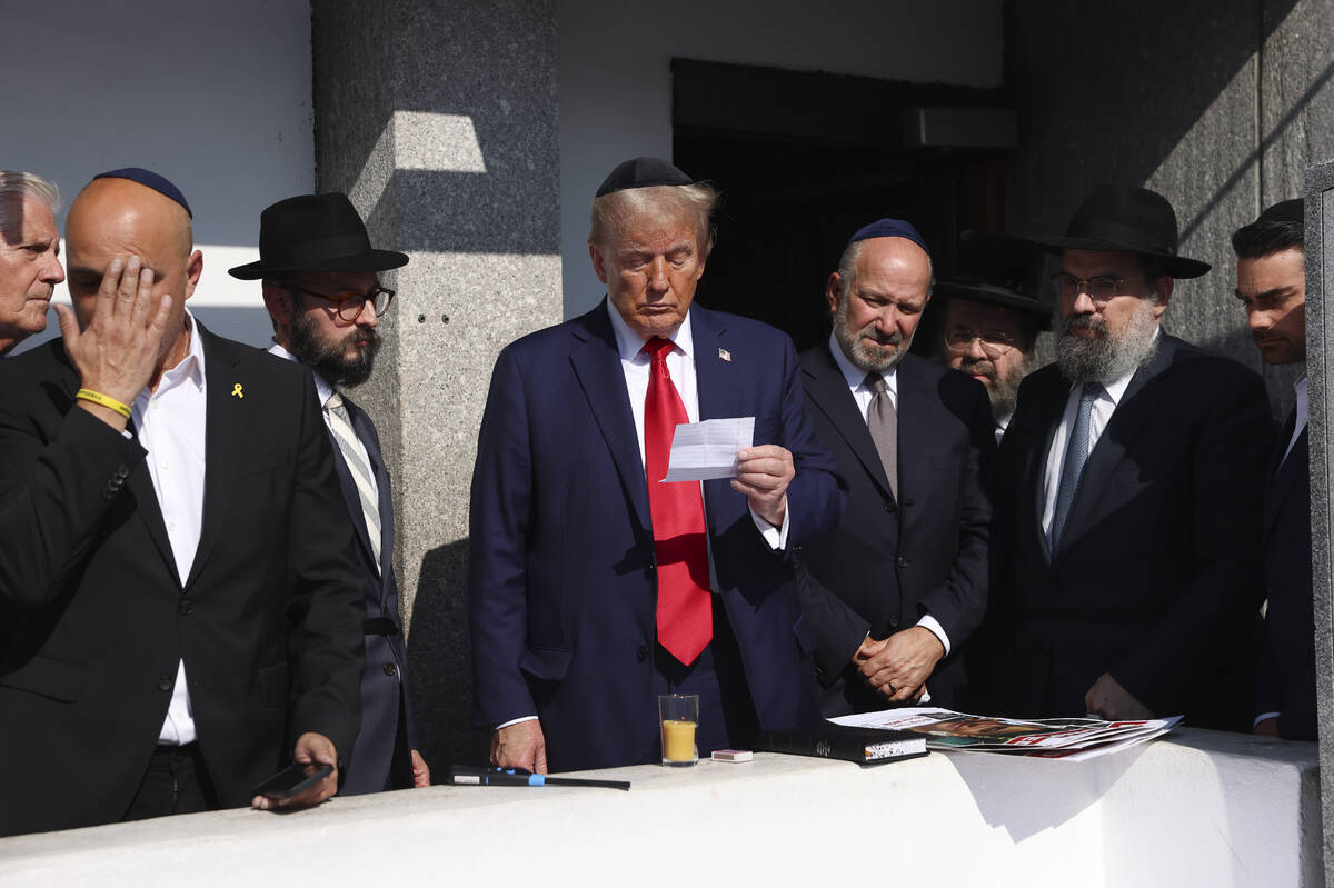 Republican presidential nominee former President Donald Trump, center, visits the gravesite of ...