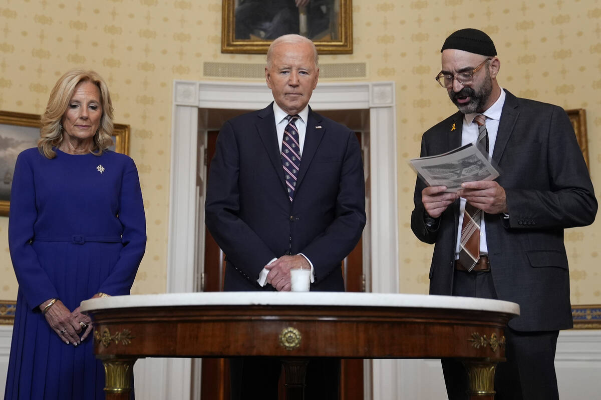 President Joe Biden, center, standing with first lady Jill Biden, left, and Rabbi Aaron Alexand ...