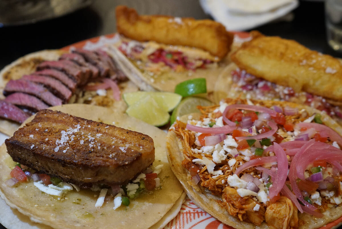 Tacos from Aroma Latin American Cocina in Henderson, clockwise from lower left: pork belly, car ...