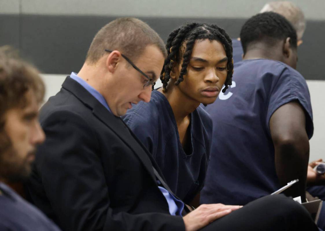 Serge Kamga, right, one of the two suspects arrested in connection with a fatal shooting that h ...