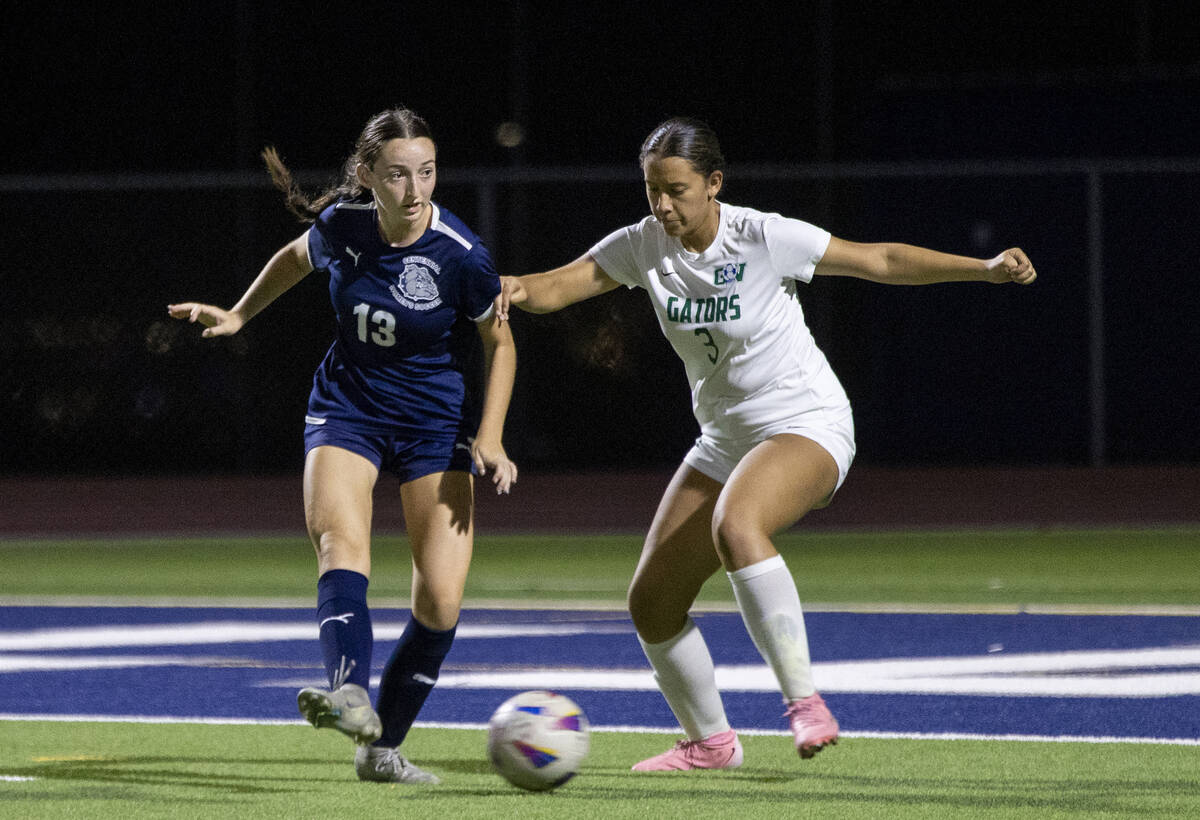 Centennial defender Ella Davis (13) and Green Valley defender Lola Chavez (3) compete during th ...