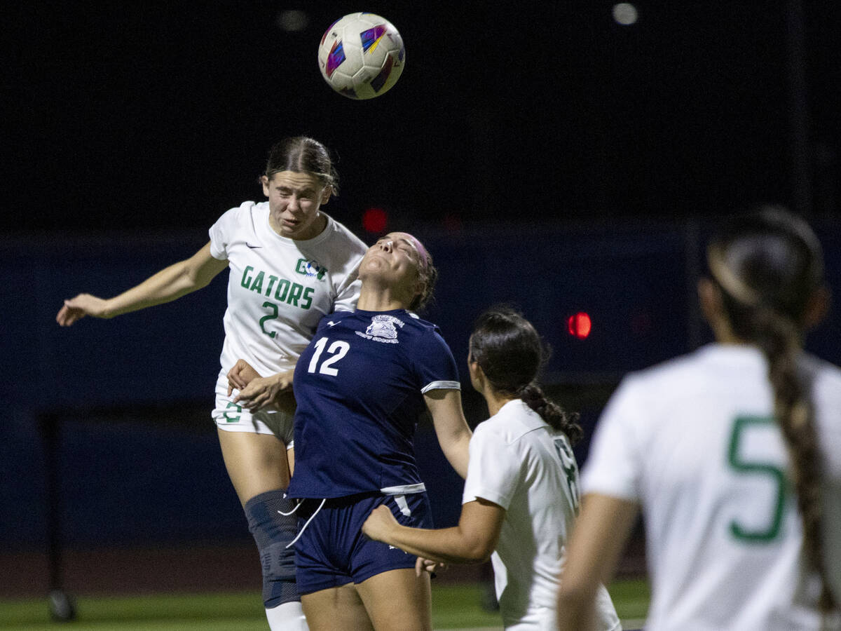 Green Valley junior Audrey Ancell (2) and Centennial defender Calina Ritcharoen (12) jump for t ...