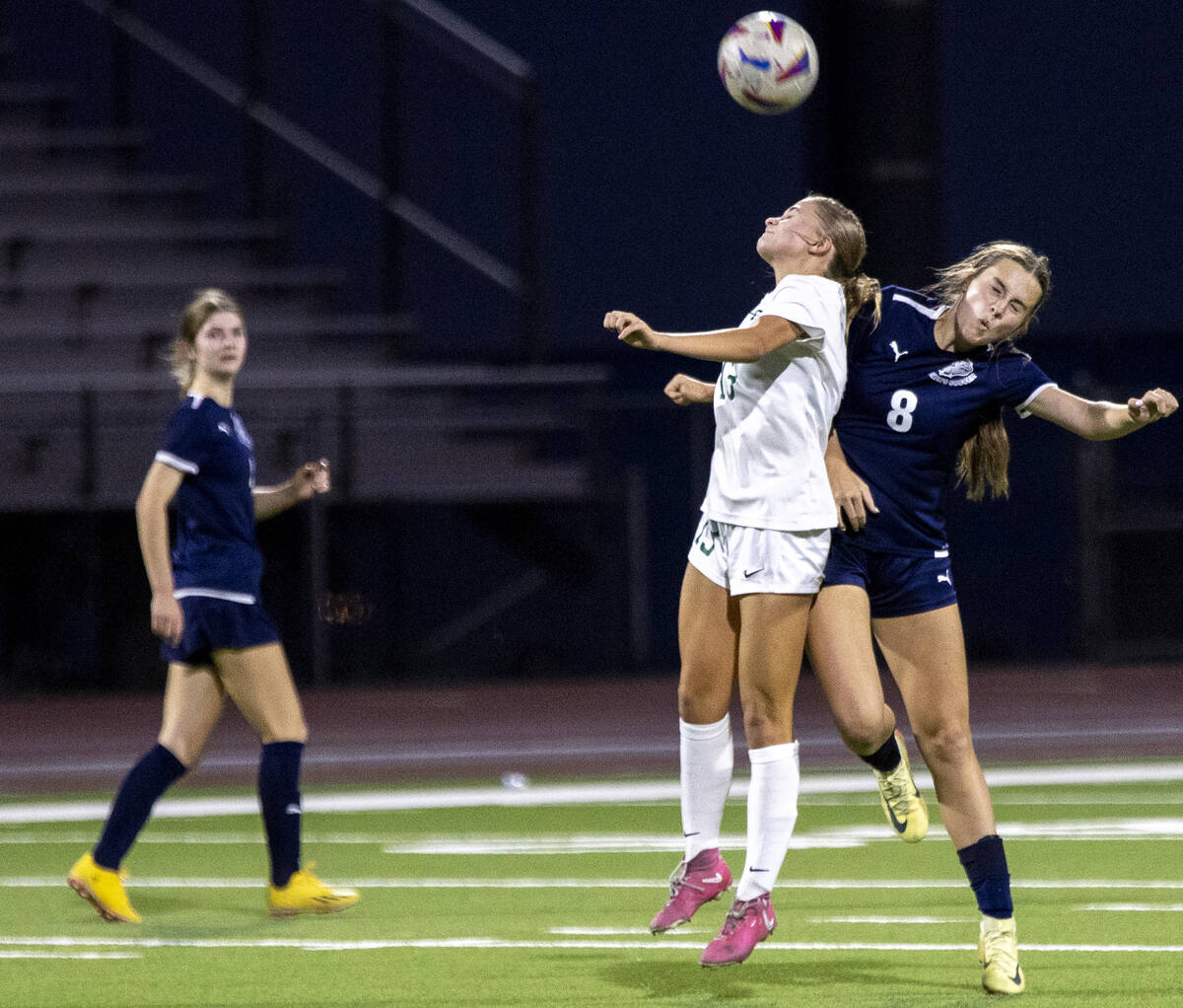 Green Valley sophomore Payton Colbrook (13) and Centennial forward Claire Orme (8) jump for the ...