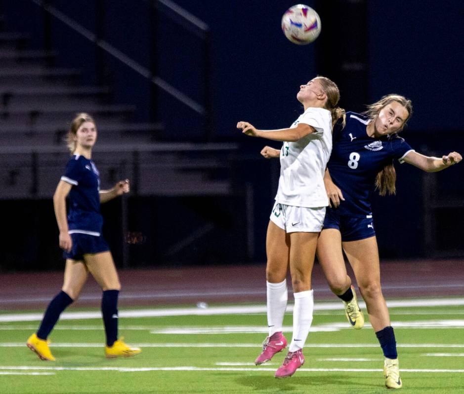 Green Valley sophomore Payton Colbrook (13) and Centennial forward Claire Orme (8) jump for the ...