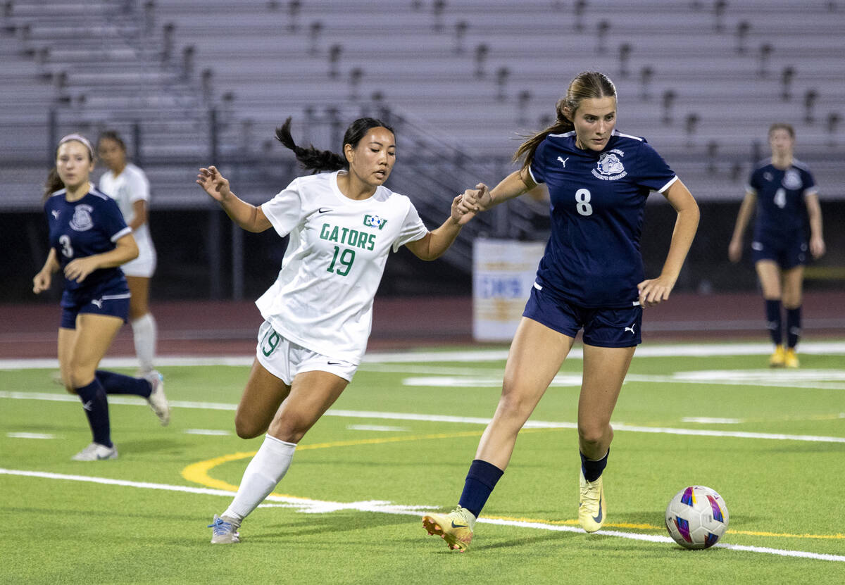 Green Valley midfielder Seira Okui (19) and Centennial forward Claire Orme (8) compete for the ...