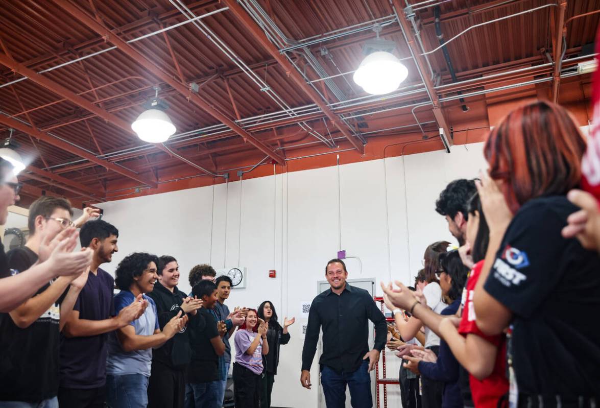 Alex Bechtler, a manufacturing teacher, reacts as students surprise him at Southeast Career Tec ...