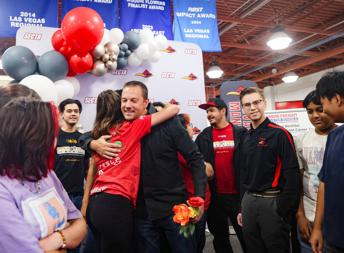 Alex Bechtler, a manufacturing teacher, hugs student Rose Hughes, 16, at Southeast Career Techn ...