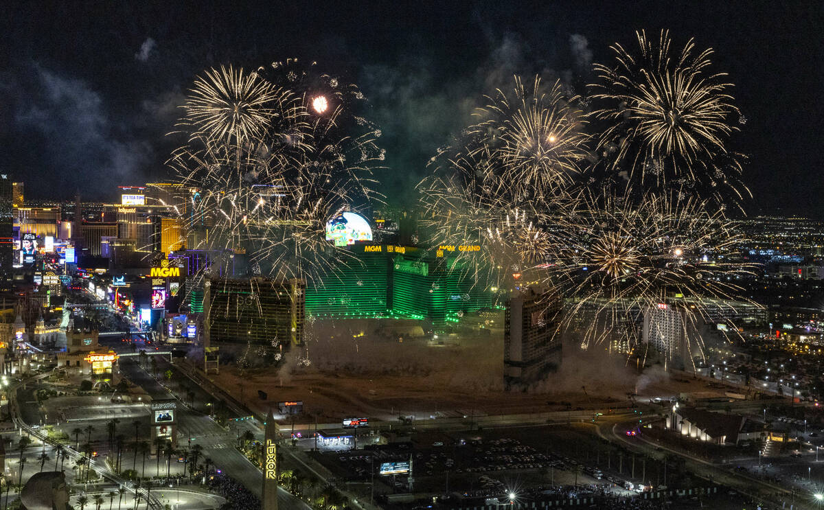 A fireworks and drone show precedes the Tropicana being imploded early in the morning while vie ...