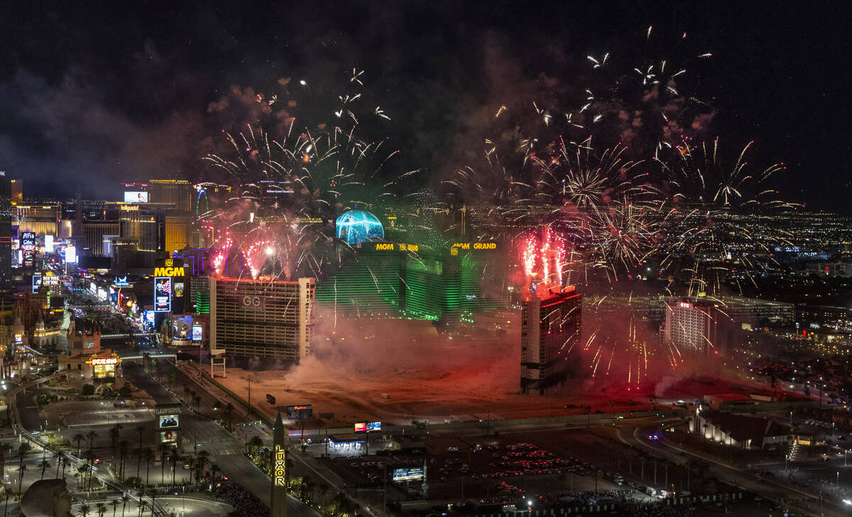 A fireworks and drone show precedes the Tropicana being imploded early in the morning while vie ...