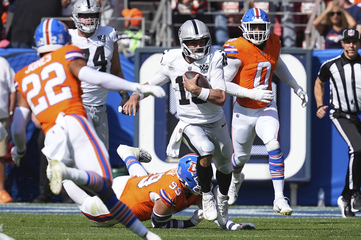 Las Vegas Raiders quarterback Gardner Minshew (15) runs with the ball against the Denver Bronco ...