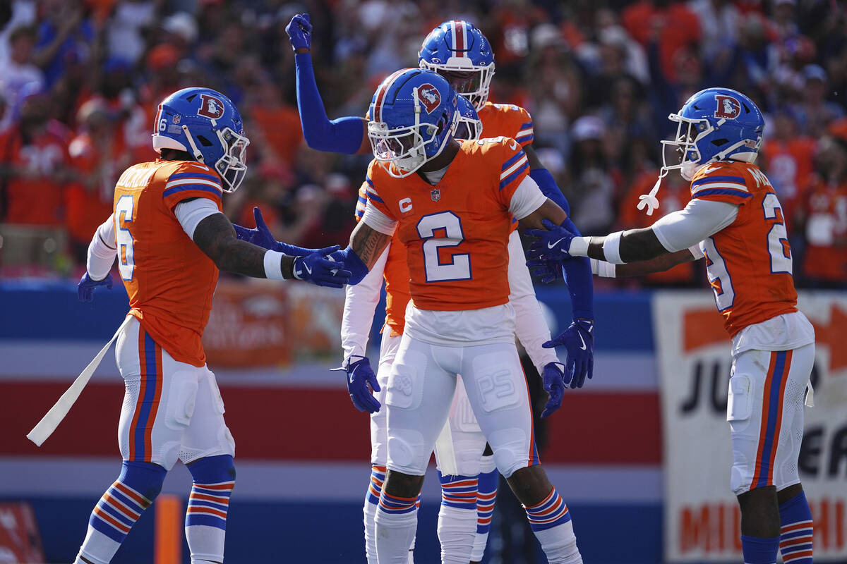 Denver Broncos cornerback Pat Surtain II (2) intercepts a pass for a 100 yard touchdown against ...