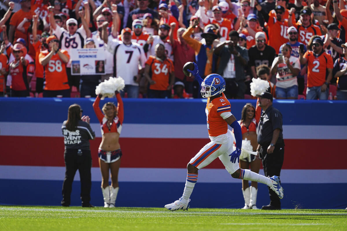 Denver Broncos cornerback Pat Surtain II (2) intercepts a pass for a 100 yard touchdown against ...