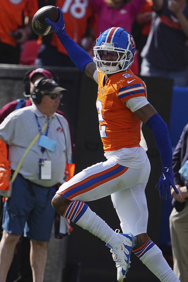 Denver Broncos cornerback Pat Surtain II (2) intercepts a pass for a 100 yard touchdown against ...