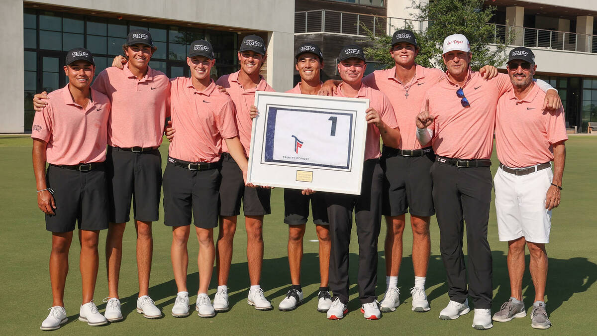 UNLV players and coaches hold the trophy following their win at the Trinity Forest Invitational ...