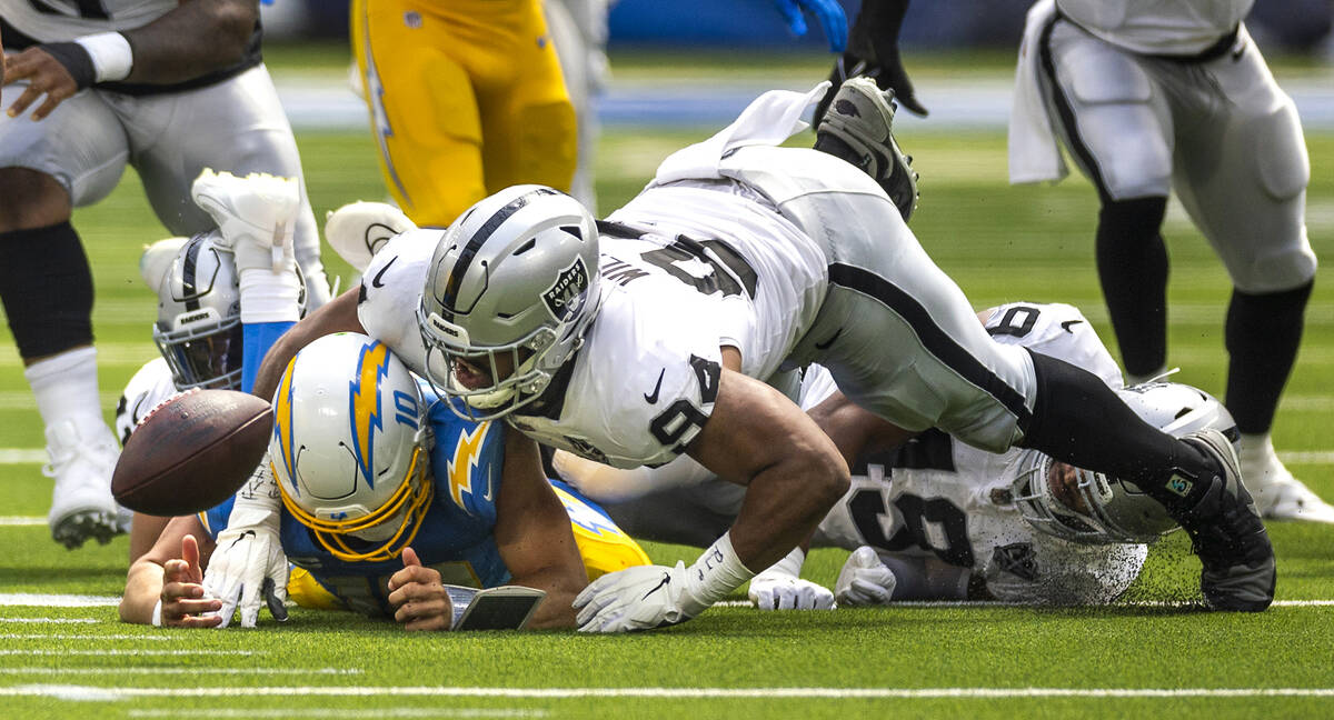 Raiders defensive tackle Christian Wilkins (94) attempts to crawl over Los Angeles Chargers qua ...