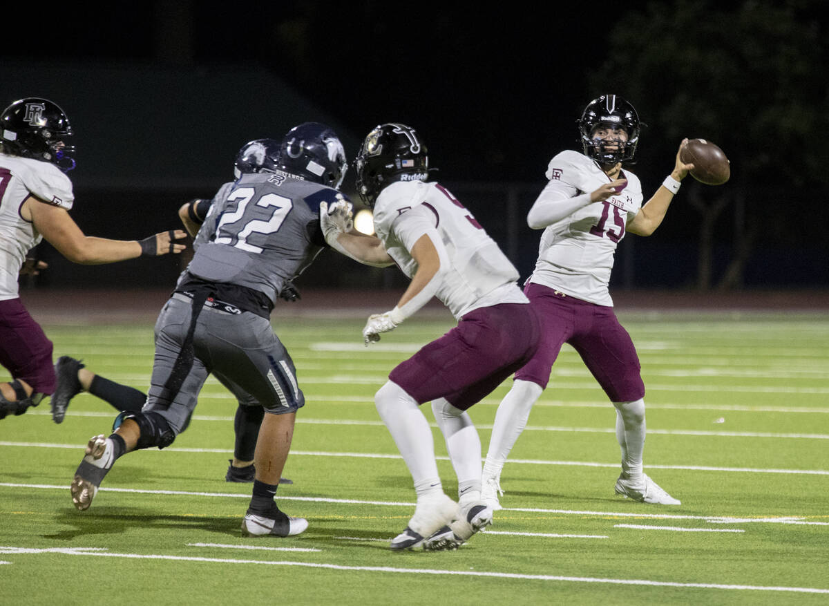 Faith Lutheran senior Alexander Rogers (15) looks to throw the ball during the high school foot ...