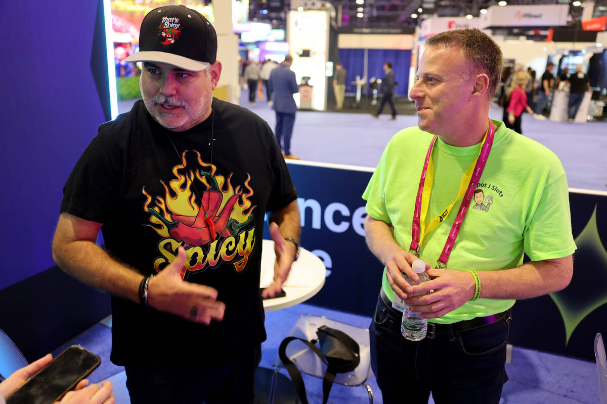 J.J. Feregrino of Uncle J Slots, left, and Jared Scott of Jackpot J Slots talk to a reporter in ...