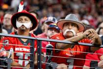 UNLV fans dressed as Rebels watch the college football game against the Syracuse Orange at Alle ...