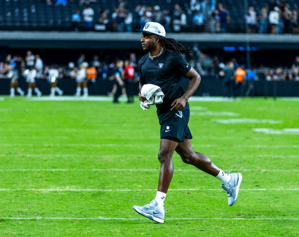 Raiders wide receiver Davante Adams (17) runs to greet fans following their loss to the Dallas ...