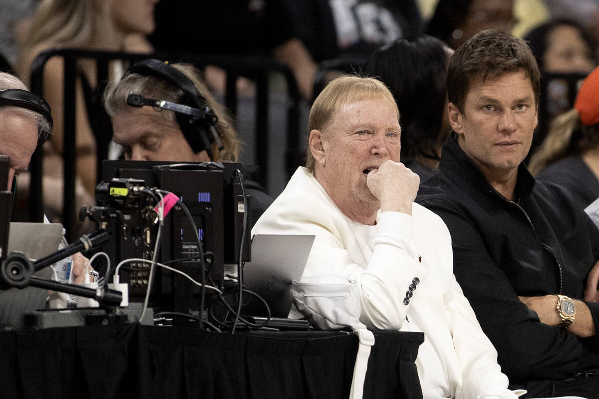 Las Vegas Aces owner Mark Davis, left, sits next to NFL superstar Tom Brady during the first ha ...