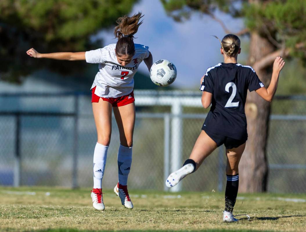 Liberty midfielder Nale'a Pomaikai (7)heads the ball past Palo Verde forward Molli O'Steen (2) ...