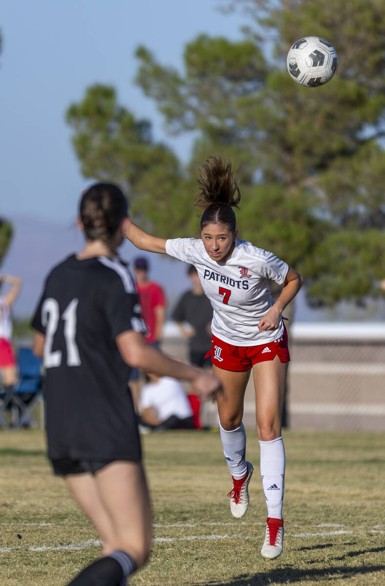 Liberty midfielder Nale'a Pomaikai (7) heads the ball past Palo Verde midfielder Gina Rumschlag ...