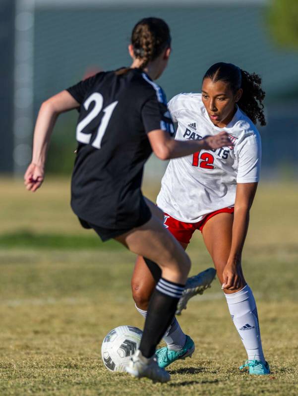 Liberty forward Ayva Jordan (12) makes a move around Palo Verde midfielder Gina Rumschlag (21) ...