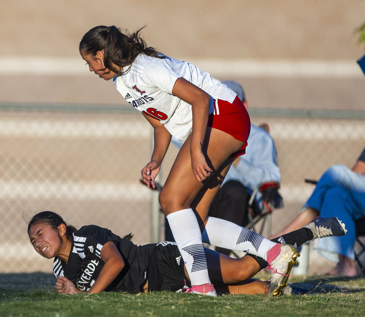 Palo Verde forward Angelie Mendoza (23) is taken down by Liberty defender Nai'a Pomaikai (16) d ...