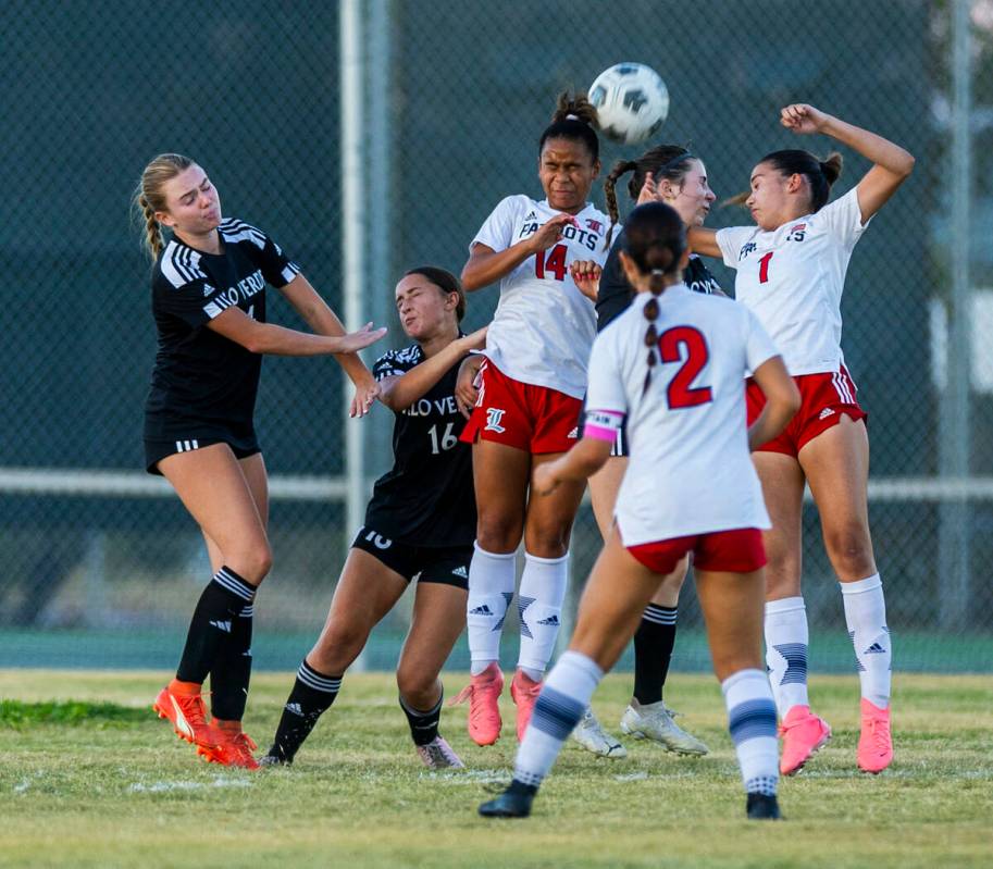 Liberty and Palo Verde players battle for a header during the second half of their NIAA soccer ...