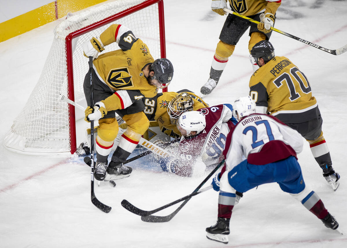 Colorado Avalanche right wing Mikko Rantanen (96) runs in to Vegas Golden Knights goaltender Ad ...