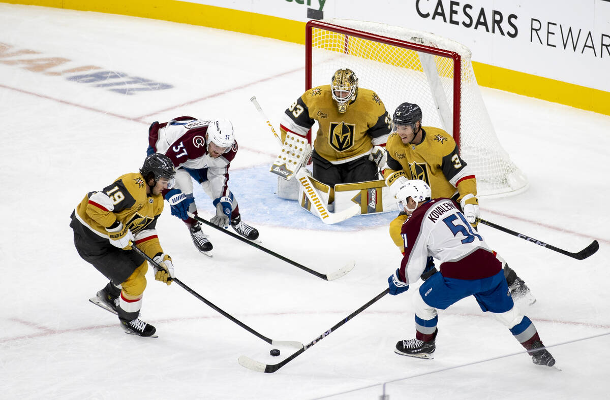 Vegas Golden Knights center Brendan Brisson (19) keeps the puck away from Colorado Avalanche ri ...