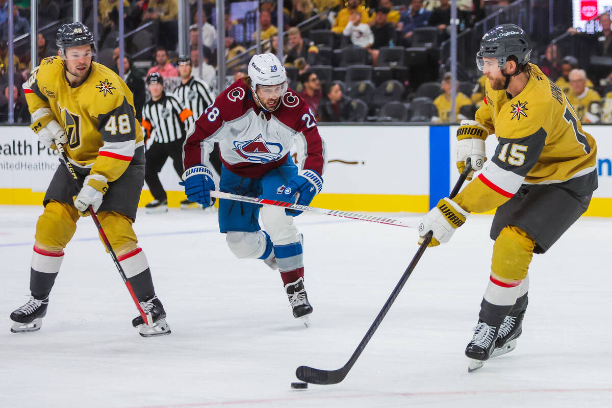 Golden Knights defenseman Noah Hanifin (15) passes the puck to a teammate as Colorado Avalanche ...