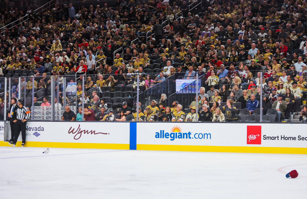 Hats thrown by Colorado Avalanche fans lay on the ice during the Golden Knights’ NHL hoc ...