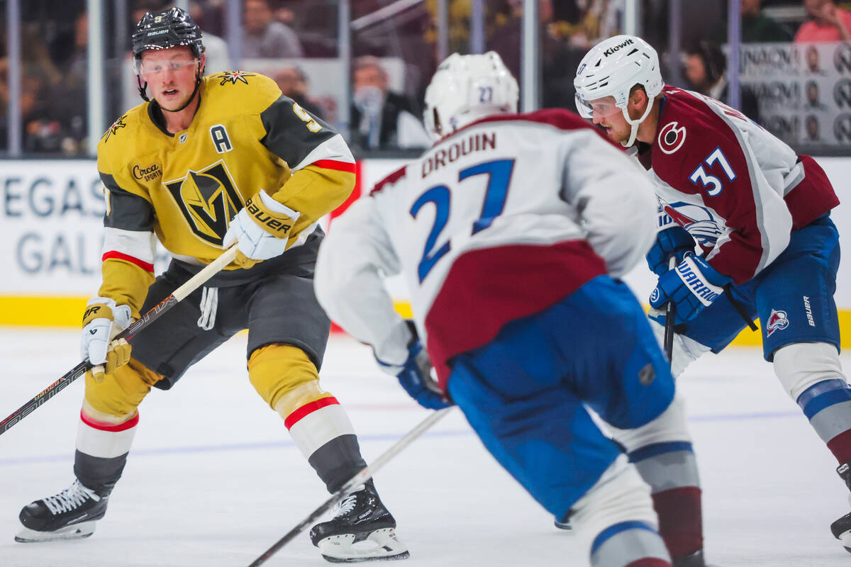 Golden Knights center Jack Eichel (9) skates the puck while Colorado Avalanche left wing Jonath ...