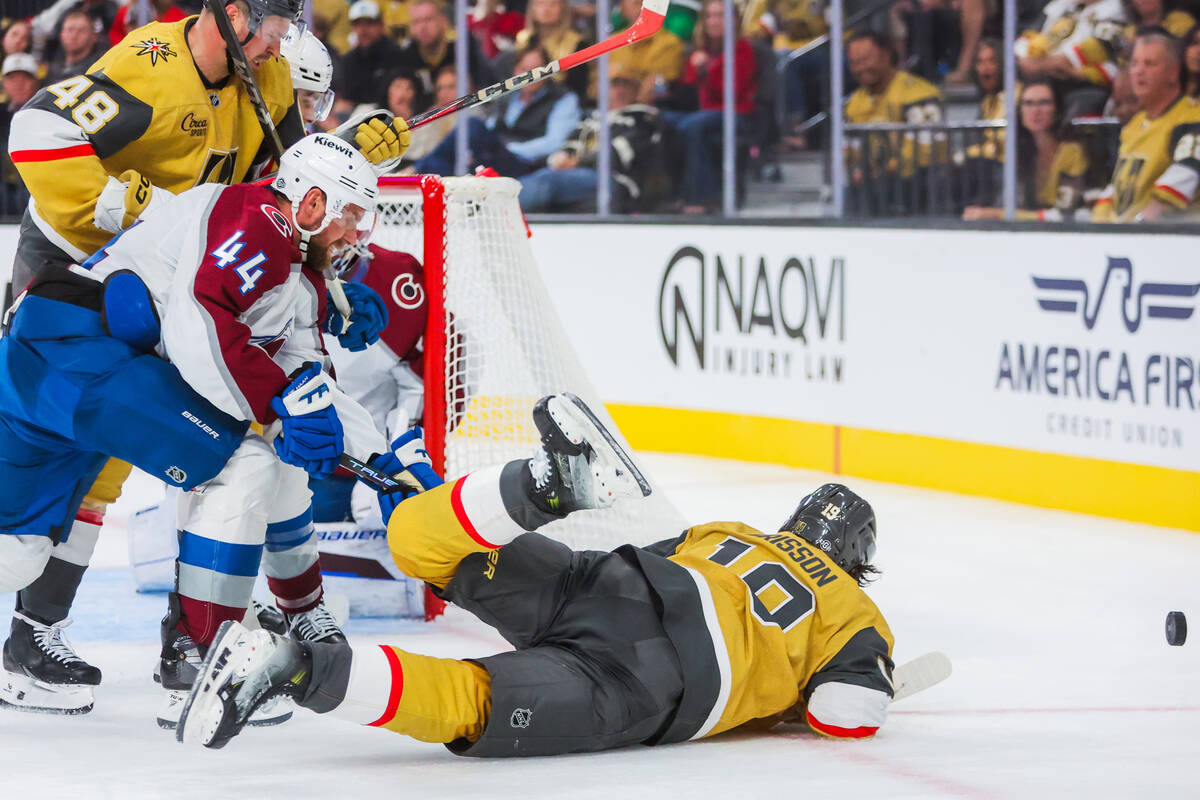 Golden Knights center Nicolas Roy (10) falls as he reaches for the puck during the Golden Knigh ...