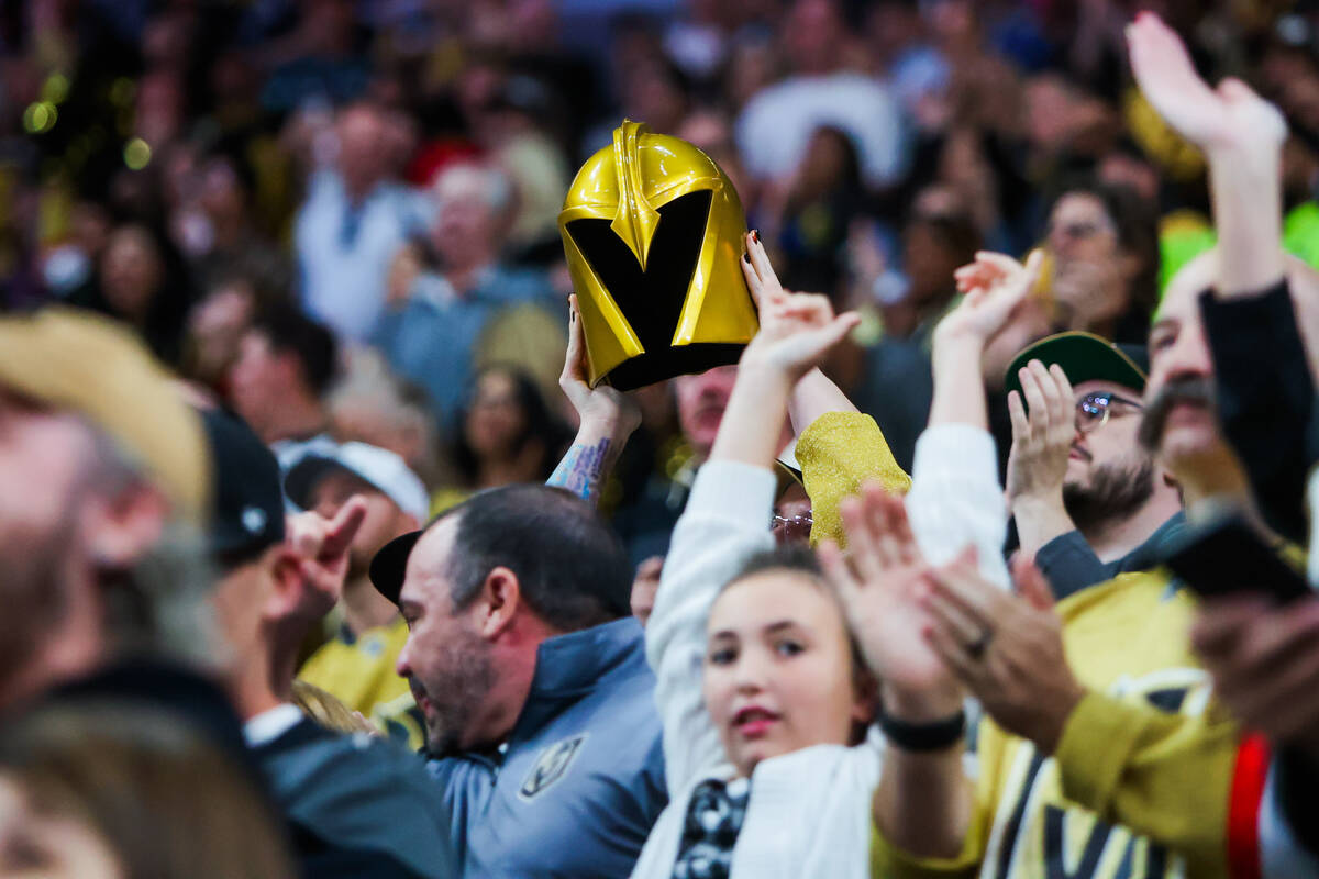 A against the Golden Knights fan holds up a helmet during the Golden Knights’ NHL hockey ...